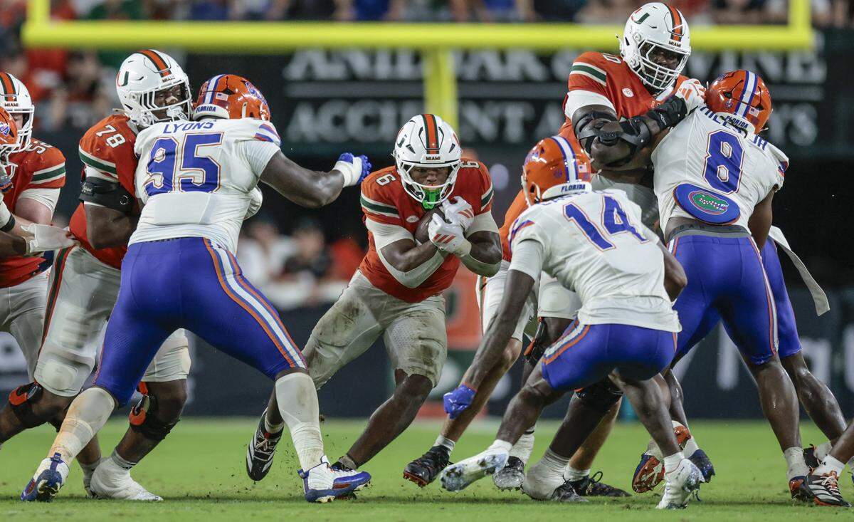 Miami Hurricanes running back CharMar Brown (6) on a carry Florida Gators during their NCAA football game at Hard Rock Stadium in Miami Gardens, Florida, on Saturday, September 20, 2025.
