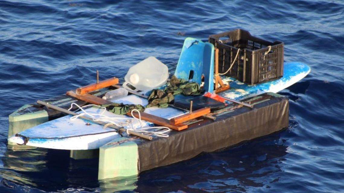 A migrant boat made of a surfboard, pontoons and a plastic chair floats in the waters off Bimini in the Bahamas Tuesday, March 29, 2022. Two men aboard the vessel were found alive after being lost at sea for a week.