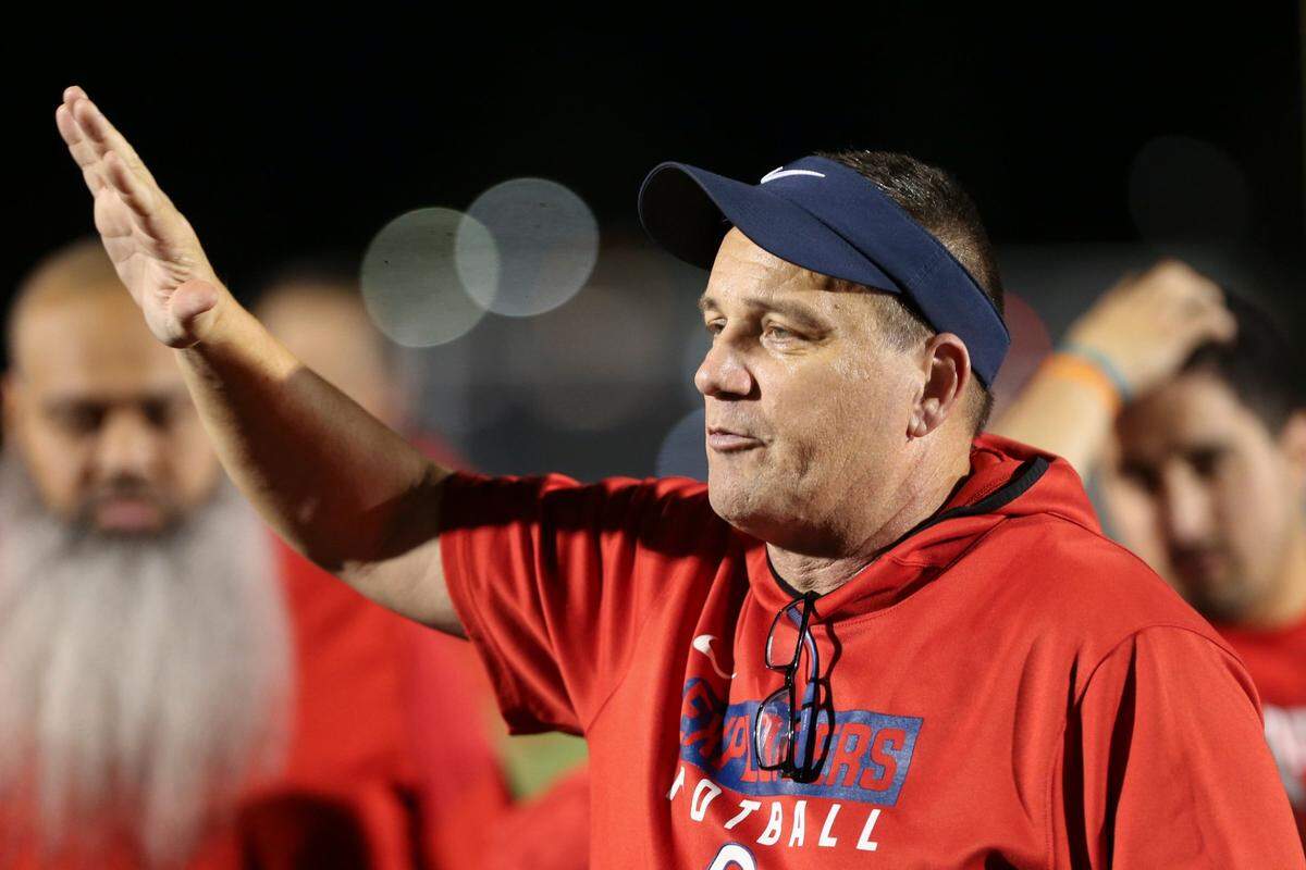 Columbus head coach Dave Dunn talks to his players after winning a high school football semifinal game against Ocoee at Tropical Park in Miami, Florida, Friday, December 2, 2022.