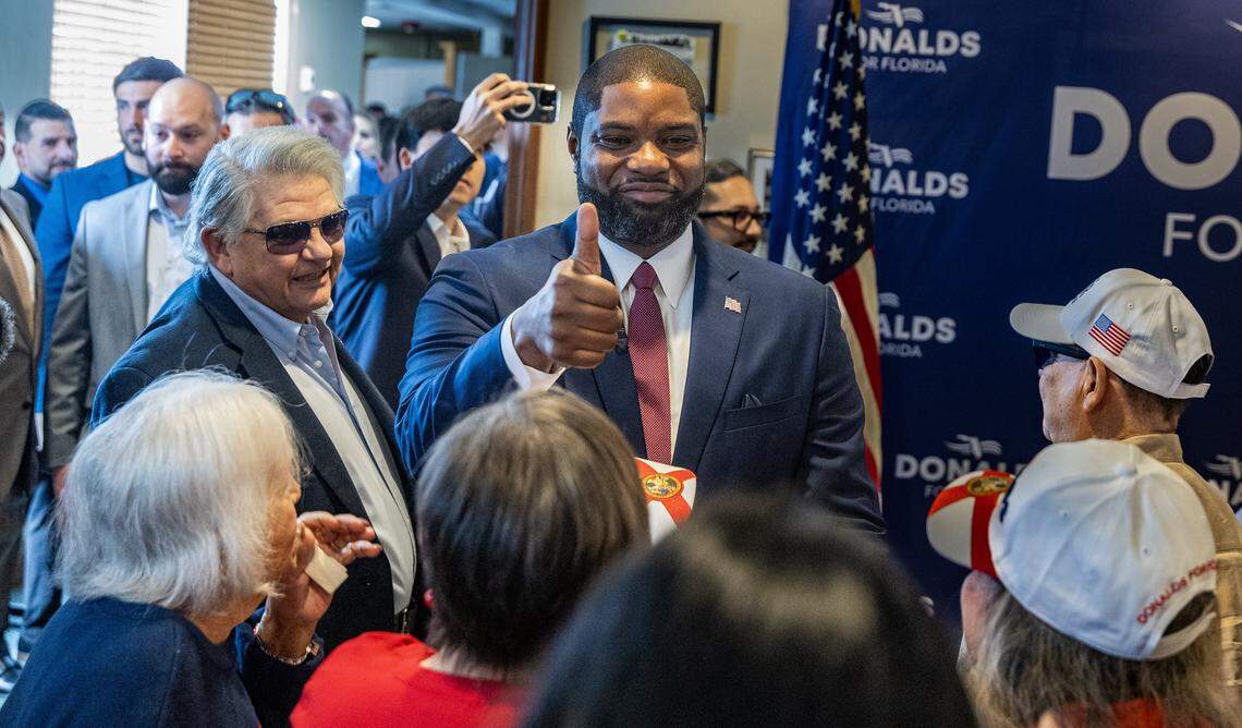 U.S. Congressman Byron Donalds greets supporters including Maximo Alvarez (left), founder and president of Sunshine Gasoline Distributors, as he enters a dinning area at the Versailles Cuban Cuisine restaurant in Little Havana, for an “Ask Byron Anything” meet-and-greet event as part of his campaign to run in the 2026 Republican primary for Florida governor, on Monday, March 02, 2026.