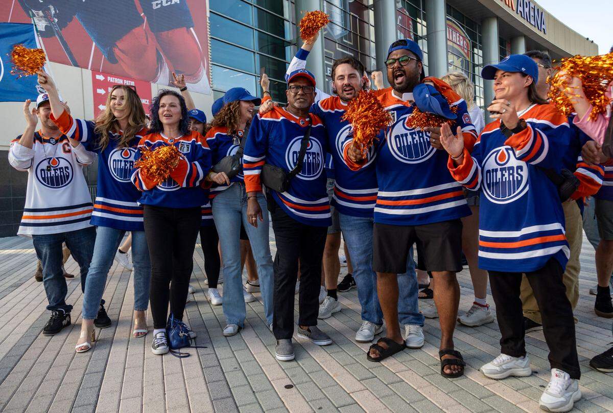 A group from Air Canada based in Edmonton chant for their team in front of Amerant Bank Arena.