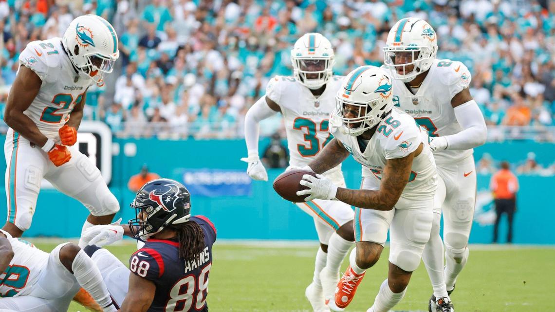 Miami Dolphins cornerback Xavien Howard (25) picks up a fumble by Houston Texans tight end Jordan Akins (88) in the second quarter at Hard Rock Stadium in Miami Gardens on Sunday, November 27, 2022.