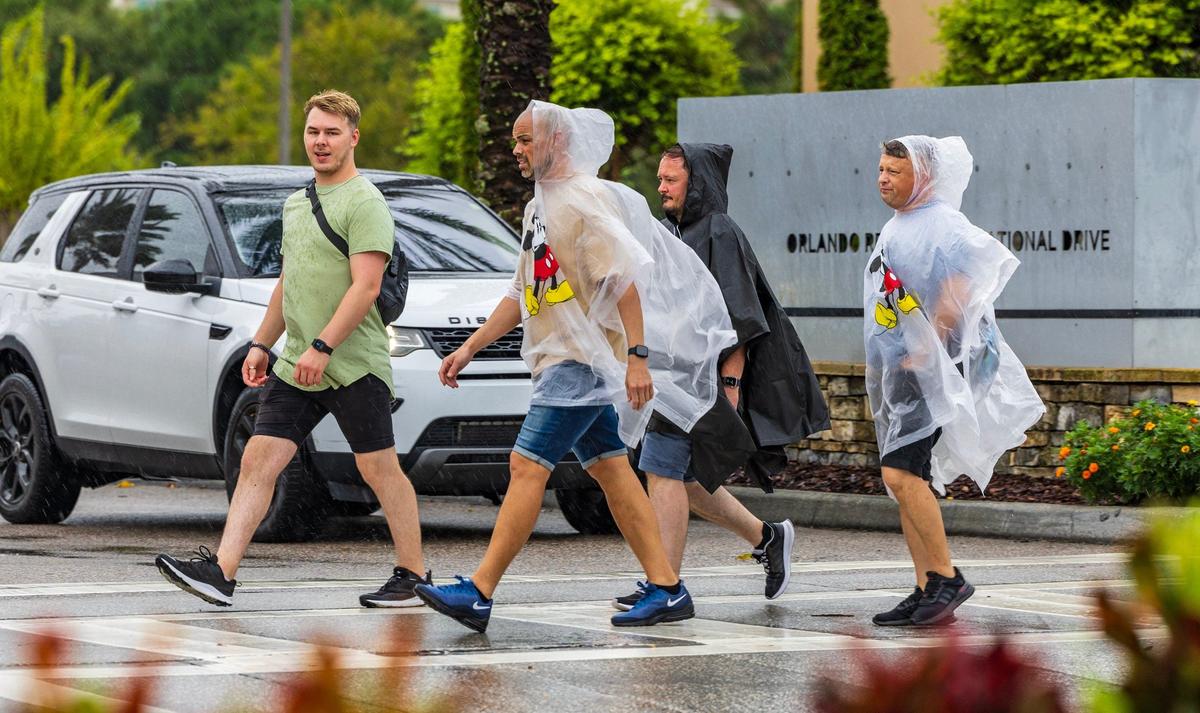 Tourists walks along Universal Boulevard in Orlando, as hurricane Milton approaches the West coast of Florida and then makes its way to the East coast, on, Wednesday October 09, 2024.