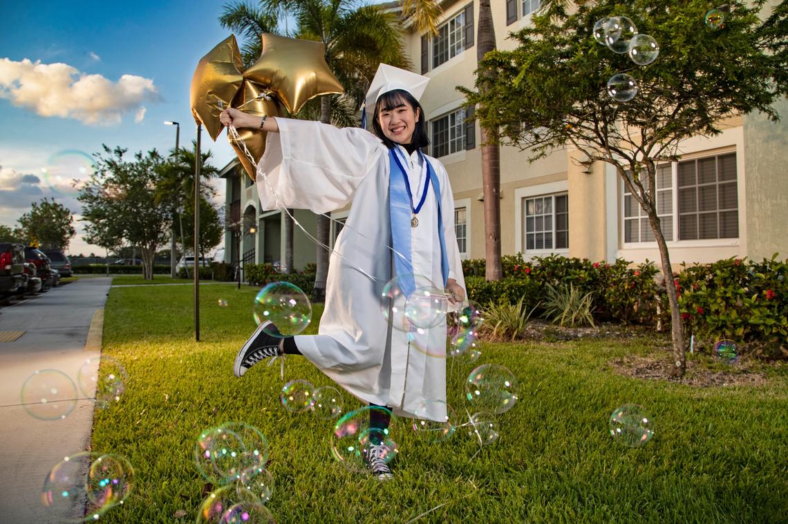 South Dade Senior High School graduate Chau Van, 17, poses for a photograph in front of her apartment building in Homestead.