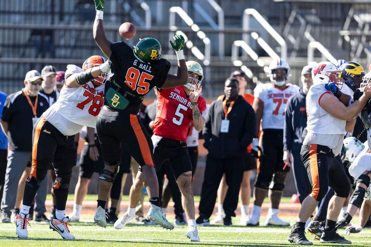 Jan 31, 2024; Mobile, AL, USA; National offensive lineman Isaiah Adams of Illinois (78) blocks National defensive lineman Gabe Hall of Baylor (95) as National quarterback Sam Hartman of Notre Dame (5) throws during practice for the National team at Hancock Whitney Stadium. Mandatory Credit: Vasha Hunt-USA TODAY Sports