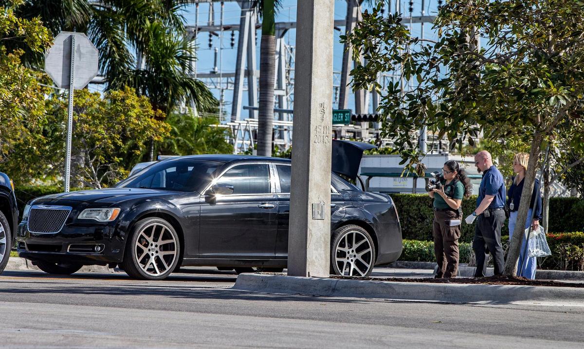 Miami-Date crime scene investigators take [pictures as they check a vehicle fitting the description of one used in a robbery to an individual after leaving a TD Bank on Tuesday night, February 01. Police were called by security personnel at the TD Bank located at 9201 W Flagler St in Miami, after noticing the suspicious car park next to the bank, resulting in the arrest of two men occupying the car. Detectives are investigating to see if they are involved in the mentioned robbery, on February 02, 2022,