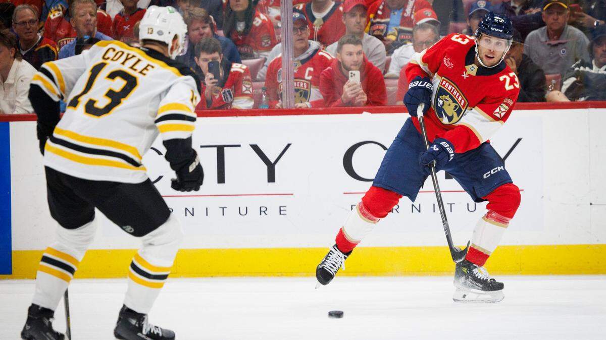 Florida Panthers center Carter Verhaeghe (23) passes the puck during the first period the home opener of the Florida Panthers against the Boston Bruins on Tuesday, Oct. 8, 2024, at Amerant Bank Arena in Sunrise, Fla.