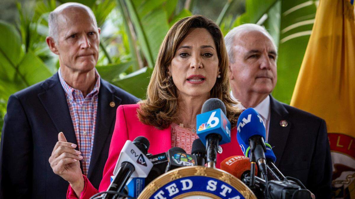Miami, Florida, January 26, 2022 - Congresswoman Maria Elvira Salazar, center, speaks during a press conference in front of Mondongo’s restaurant in Doral. Senator Rick Scott, left, and Congressman Carlos Gimenez, right are in the background.
