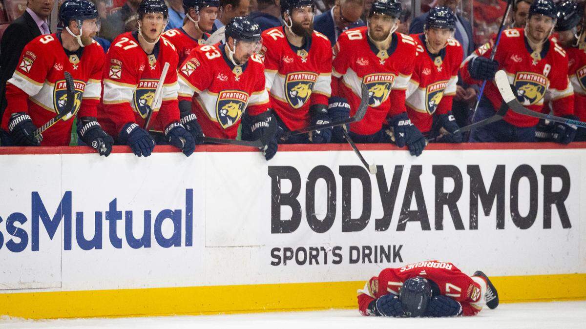 Florida Panthers center Evan Rodrigues (17) lays on the ground after being hit by Toronto Maple Leafs defenseman Oliver Ekman-Larsson (95) during the third period of Game 4 of a Stanley Cup playoffs second-round series on Sunday, May 11, 2025, at Amerant Bank Arena in Sunrise, Fla. The Florida Panthers won 2-0.