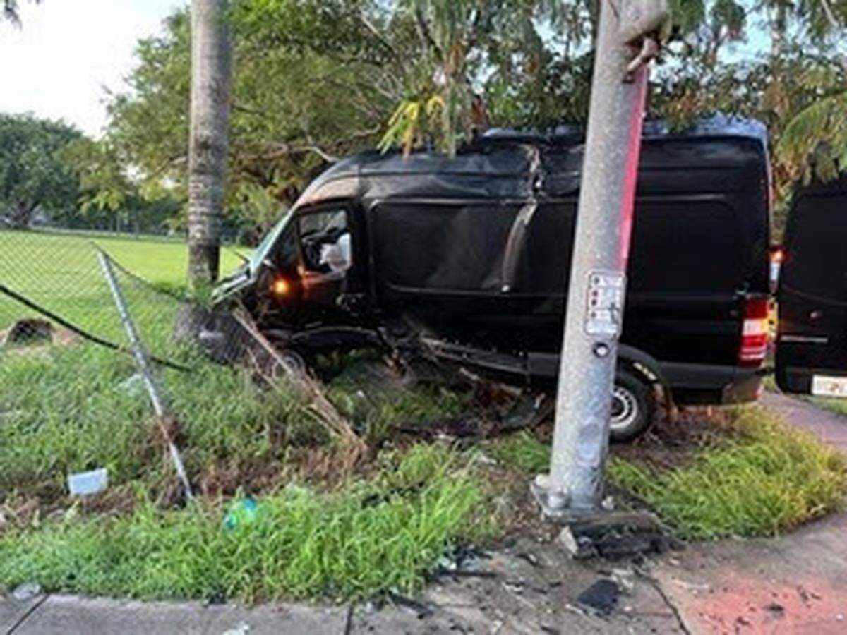 A utility van is parked on the side of the road in Homestead after a car crashed into it. U.S. Immigrations and Customs Enforcement says a man illegally in the country from Guatemala crashed his car into the van after hitting an agent Sunday, Sept. 14, 2025.