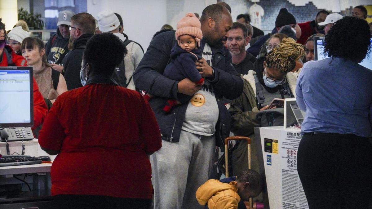 Southwest Airlines ticket holder Cameron Bradley tries to rebook a flight for his family to Atlanta after a cancellation at LaGuardia Airport in New York before Christmas.