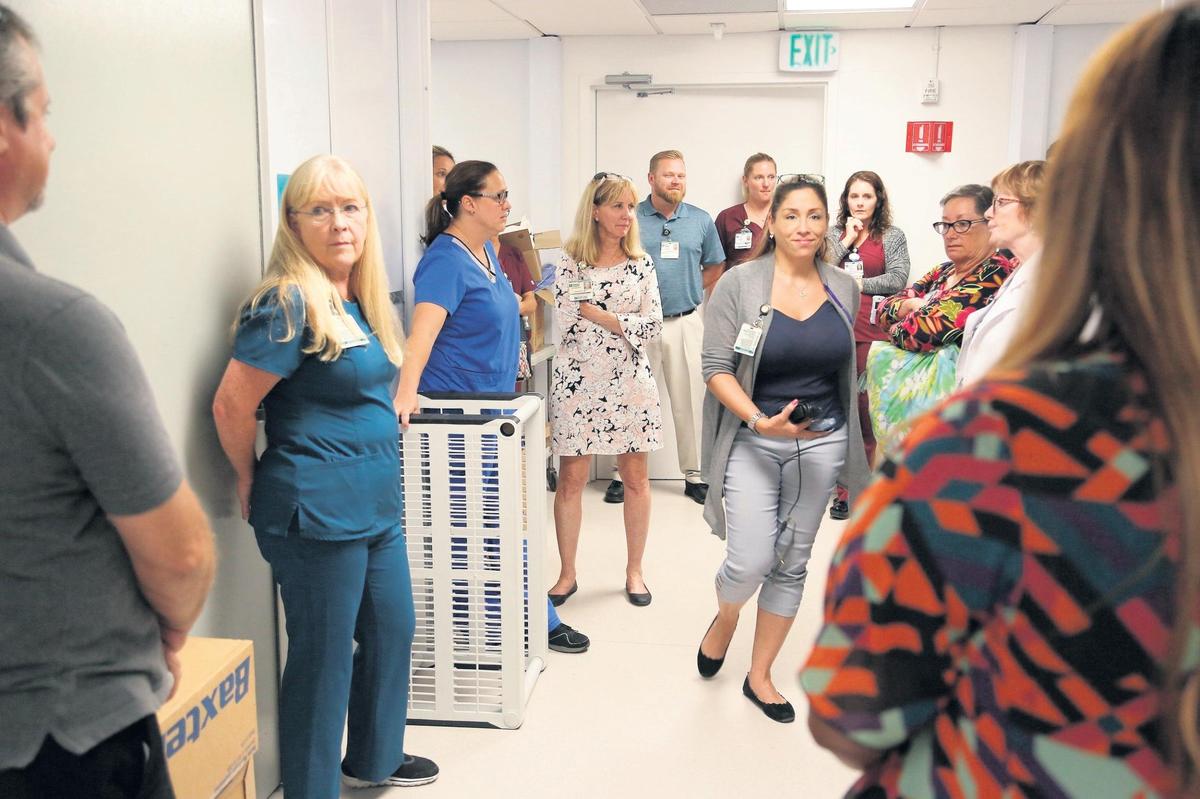 Staff members huddle between shifts in the emergency room area of the modular hospital on Tuesday, July 24, 2018. Fishermen’s Hospital in Marathon reopened on Monday. The hospital was heavily damaged by Hurricane Irma last September.