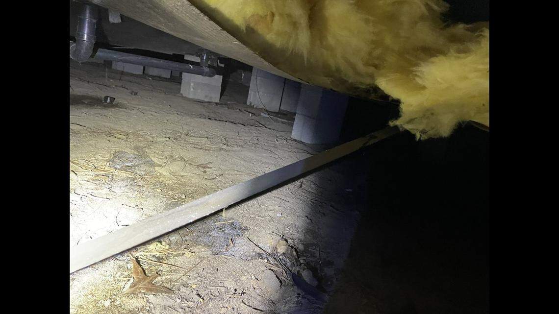 The opening allowed the suspect to crawl among the piers supporting the home’s foundation, photos show.