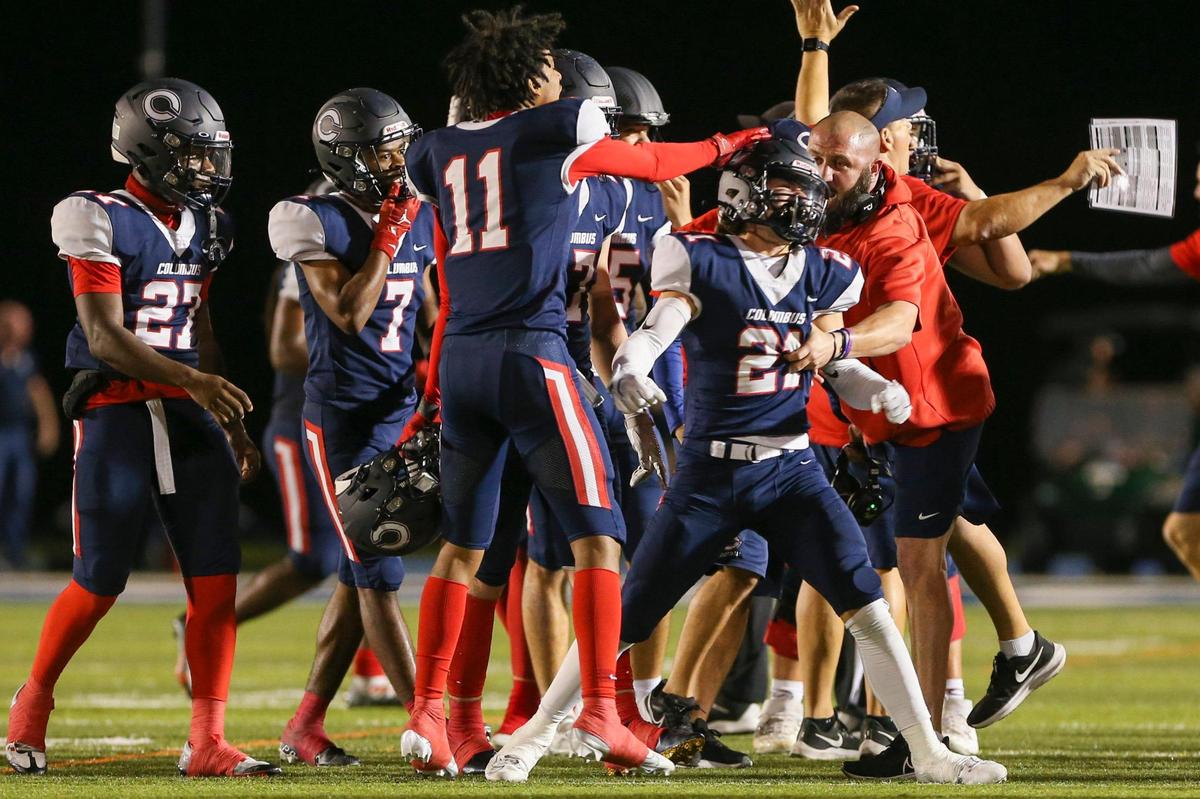 Columbus cornerback Cameron Pineda (21) celebrates after intercepting the football during the fourth quarter of a high school football semifinal game against Ocoee at Tropical Park in Miami, Florida, Friday, December 2, 2022.