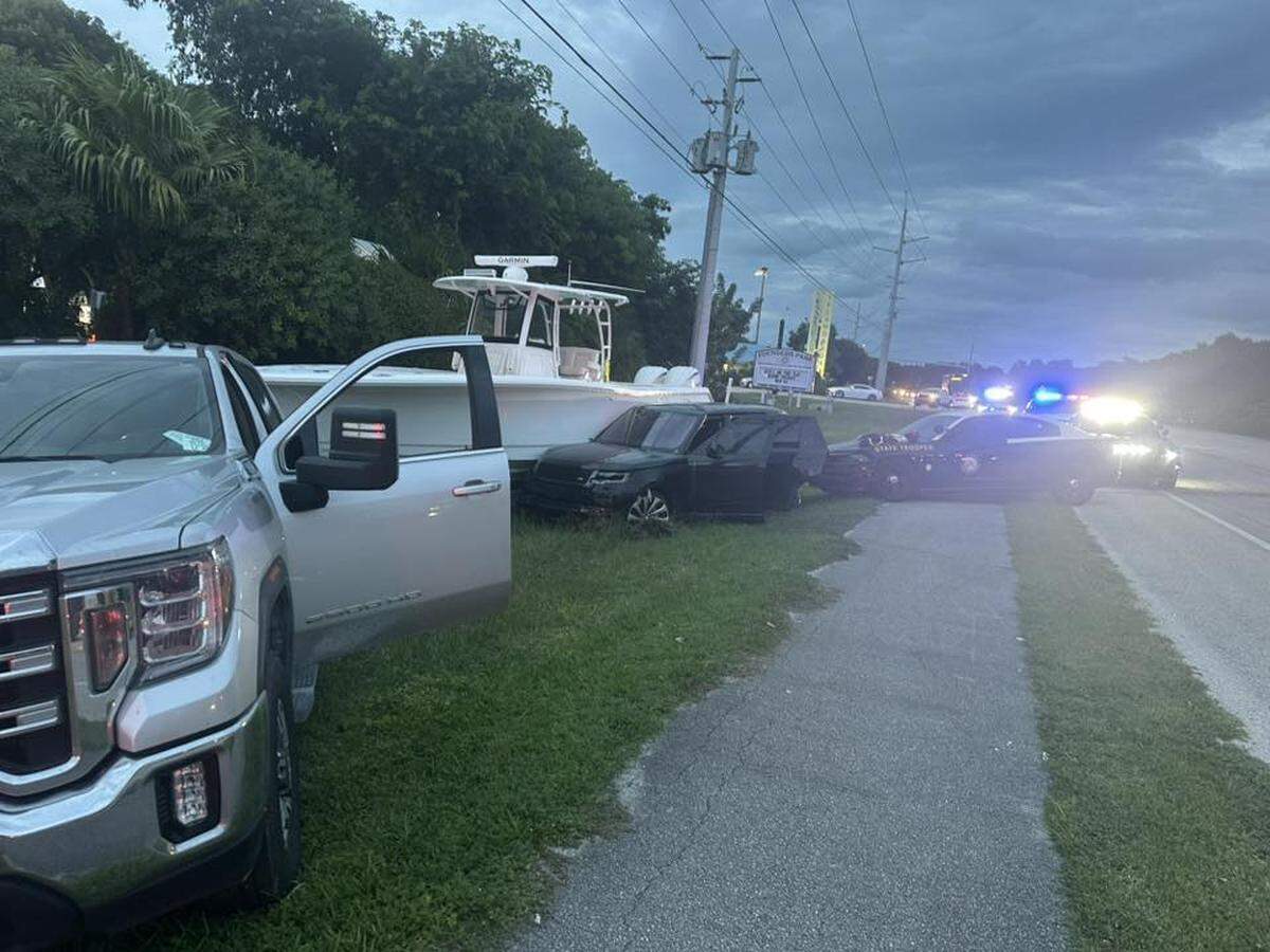 A Range Rover SUV is parked after crashing into a boat being carried on a trailer on the southbound shoulder of U.S. 1 in Islamorada in the Florida Keys Tuesday, Nov. 4, 2025.