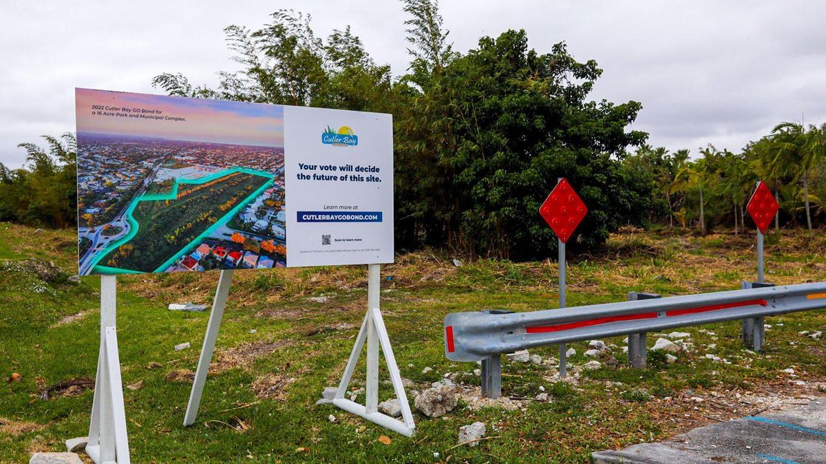 A roadside sign in Cutler Bay stands at the edge of a 16-acre plot of former farmland the town wants to convert into a park and municipal center. The sign urges voters in the South Miami-Dade County town to cast ballots in a mail-in referendum that if approved would authorize the city to raise up to $37 million for the project.