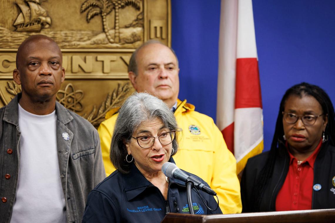 Mayor Daniella Levine-Cava, front, addresses the public while Commission Chair Oliver G. Gilbert, left, and Commissioner Juan Carlos Bermudez, center, and Marleine Bastien, right, listen during a press conference discussing what Miami-Dade is doing for Hurricane Milton on Monday, Oct. 7, 2024, at the county Emergency Operations Center in Doral, Fla.