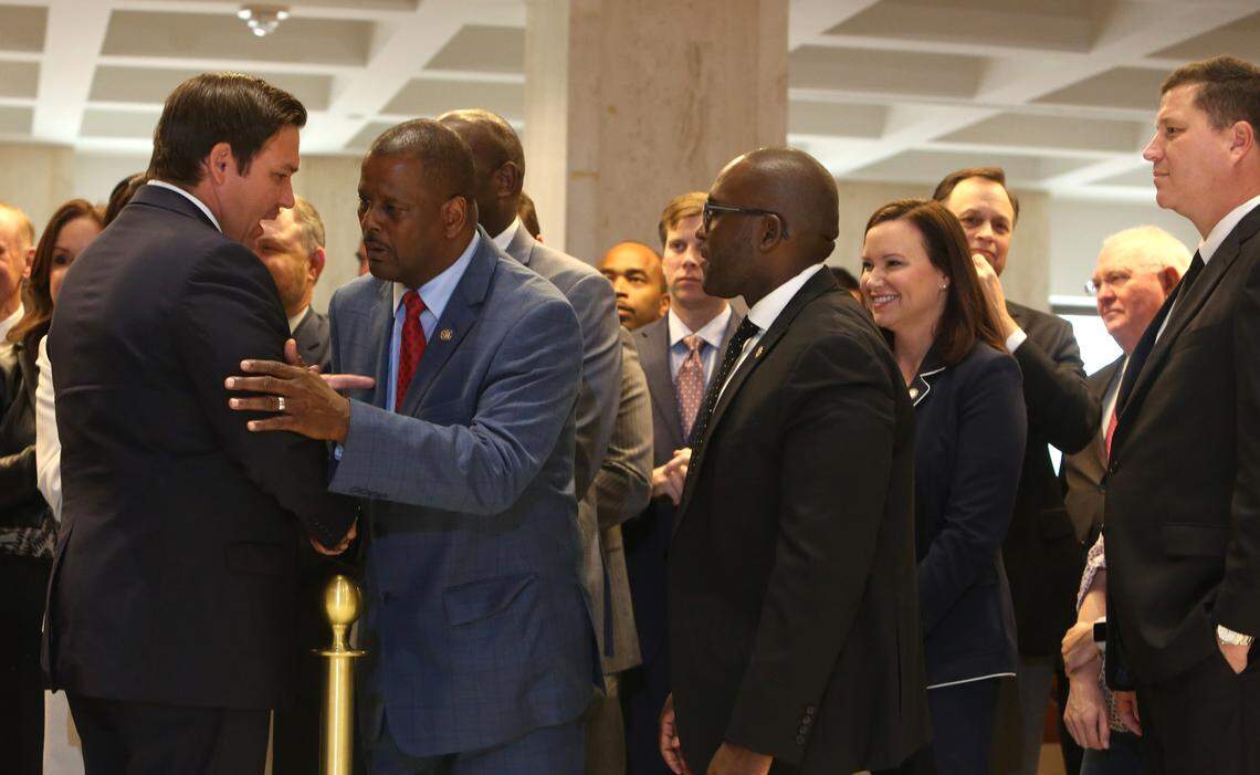 SCOTT KEELER | Times Left to Right: Florida Governor Ron DeSantis talks with Rep. Dr. James Bush, D- Miami as Rep. Shevrin Jones, D- West Park, Attorney General Ashley Moody, and Senator Jeff Brandes, R- St. Petersburg, look on at Sine Die at the Capitol, Saturday, May 4, 2019.