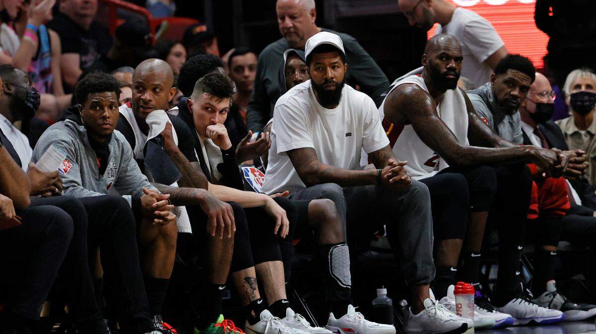 Miami Heat players Kyle Lowry (7) P.J. Tucker (17) Tyler Herro (14) Victor Oladipo (4) Markieff Morris (8) Bam Adebayo (13) Dedmon (21) and Udonis Haslem (40) look from the bench during the fourth quarter of their NBA basketball game against the Phoenix Suns at the FTX Arena on Wednesday, March 9, 2022 in Miami, Fl.