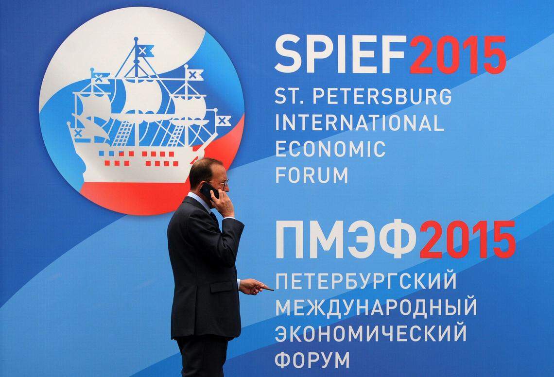 A man talks on a phone close to a banner bearing the logo of the St Petersburg International Economic Forum (SPIEF 2015) in St. Petersburg on June 18, 2015. AFP PHOTO / OLGA MALTSEVA        (Photo credit should read OLGA MALTSEVA/AFP via Getty Images)