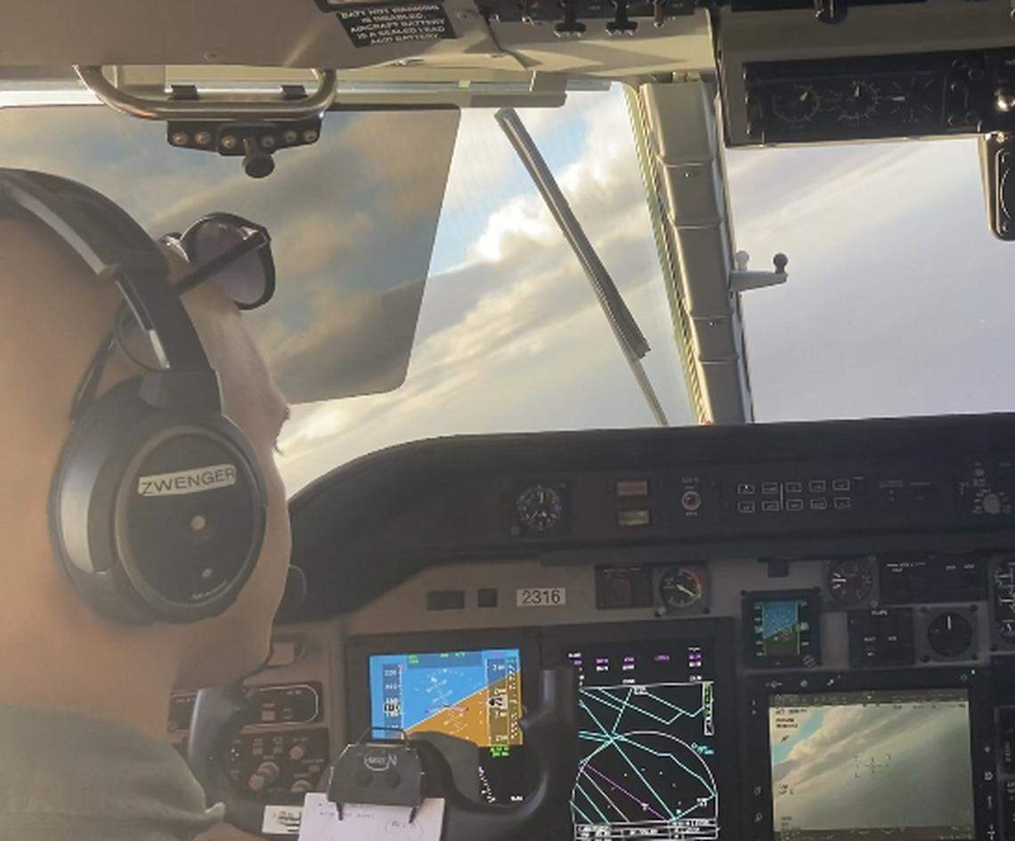 U.S. Coast Guard pilot Lt. Spencer Zwenger flies from the left side of the cockpit of a C-144 Ocean Sentry patrol plane over the Florida Straits Saturday, Jan. 14, 2023.