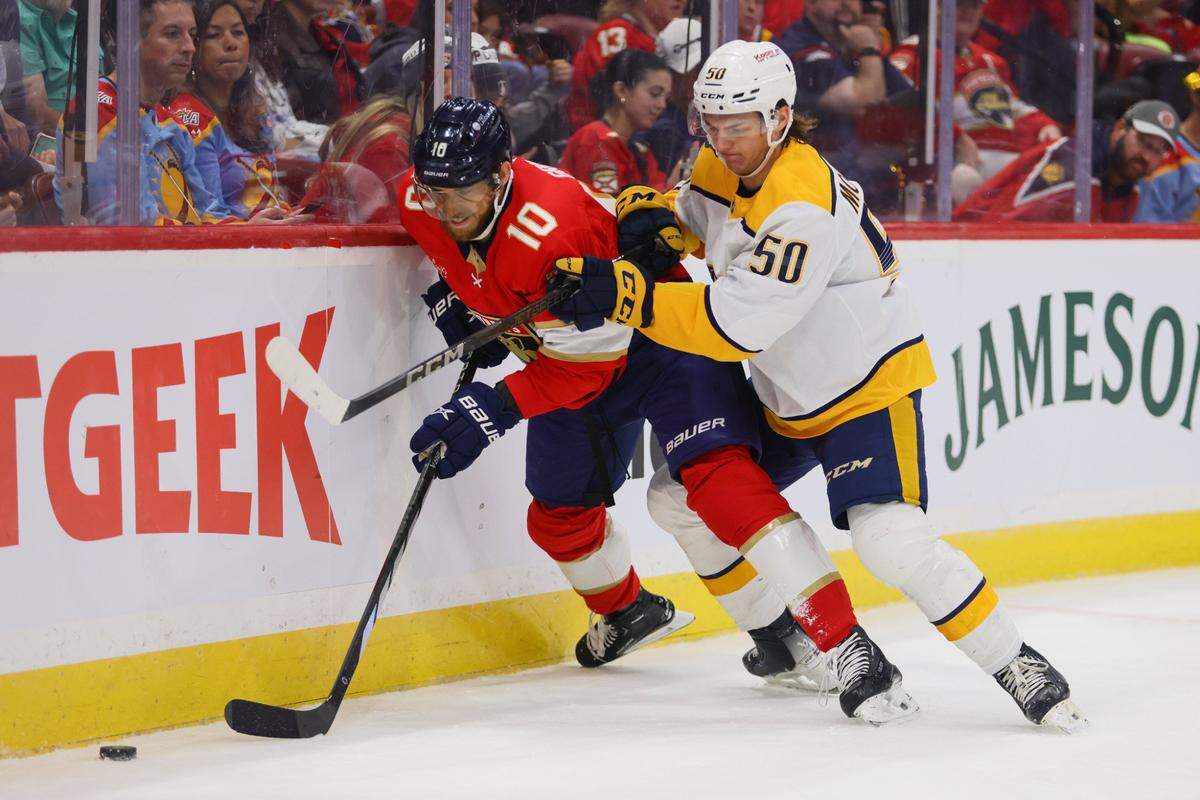 Florida Panthers left wing A.J. Greer (10) battles for the puck against Nashville Predators defenseman Tanner Molendyk (50) during the first period of an NHL preseason game at Amerant Bank Arena in Sunrise, Florida, on Sunday, September 22, 2024.