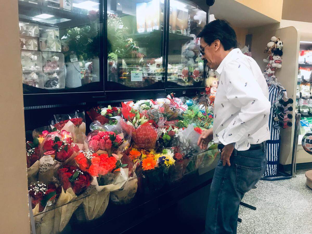 Orlando Duran selects a bouquet of flowers for his daughter, Alexa.