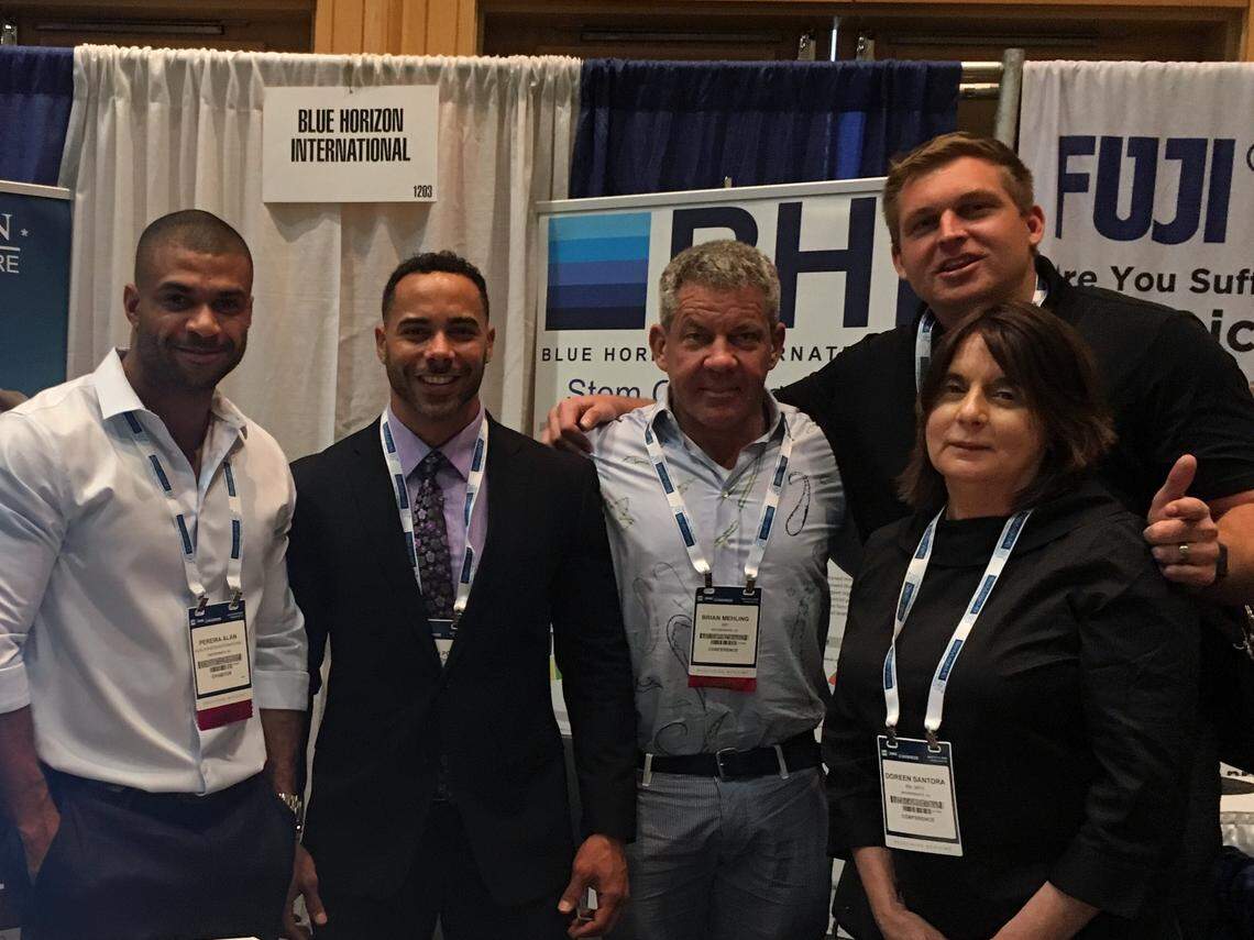 Dr. Brian Mehling (center) and his team promote cord cell treatments at anti-aging conference. Former Ohio State lineman, Krik Barton (back right) partnered after a successful treatment.