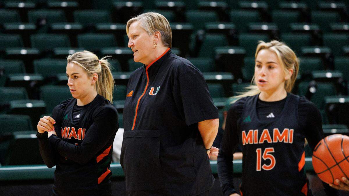 Head Coach Tricia Cullop talks to the Cavinder twins, Haley Cavinder (14) and Hanna Cavinder (15) during practice after media day on Monday, Oct. 21, 2024, at the University of Miami. Now graduate students, the Cavinder twins, basketball players and Tiktok stars, return to Miami for another season.