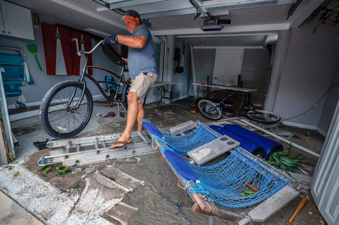 Manasota Key resident Lee White clears out his garage two days after Hurricane Milton hit Florida.