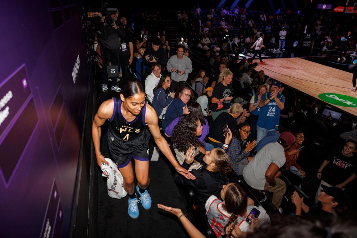 Lunar Owls BC’s Skylar Diggins-Smith (4) high-fives fans after putting her name on the board to advance to the next round during the 1-on-1 tournament for Unrivaled, a women’s pro basketball league that launched this season in Miami, on Monday, Feb. 10, 2025, at Wayfair Arena in Medley, Florida.