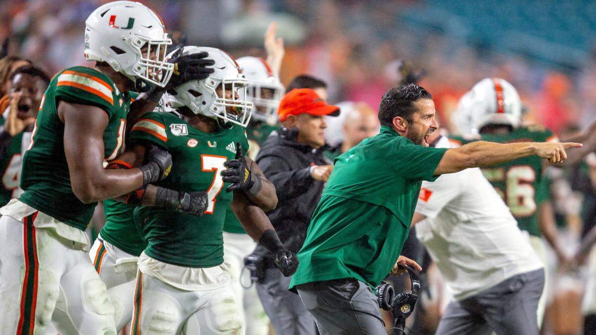 Miami Hurricanes head coach Manny Diaz and the Canes sideline react after a recovered fumble by Jimmy Murphy (29) during their Nov. 9 win against Louisville.