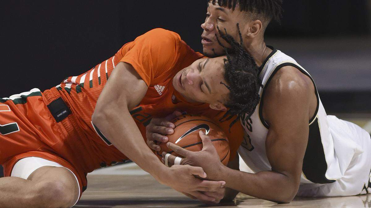 University of Miami guard Isaiah Wong battles for the ball during a 66-54 road loss to Wake Forest. Wong left the game with a sprained ankle.