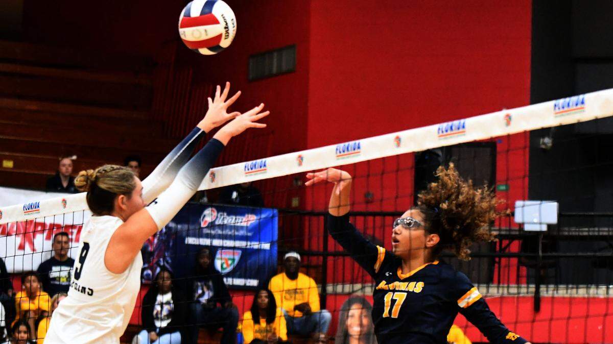 St. Thomas Aquinas junior Sydney Guerrier pushes a shot over the net against Gulf Breeze during the Class 6A girls volleyball state championship game on Saturday at Polk State College in Winter Haven, Fla.