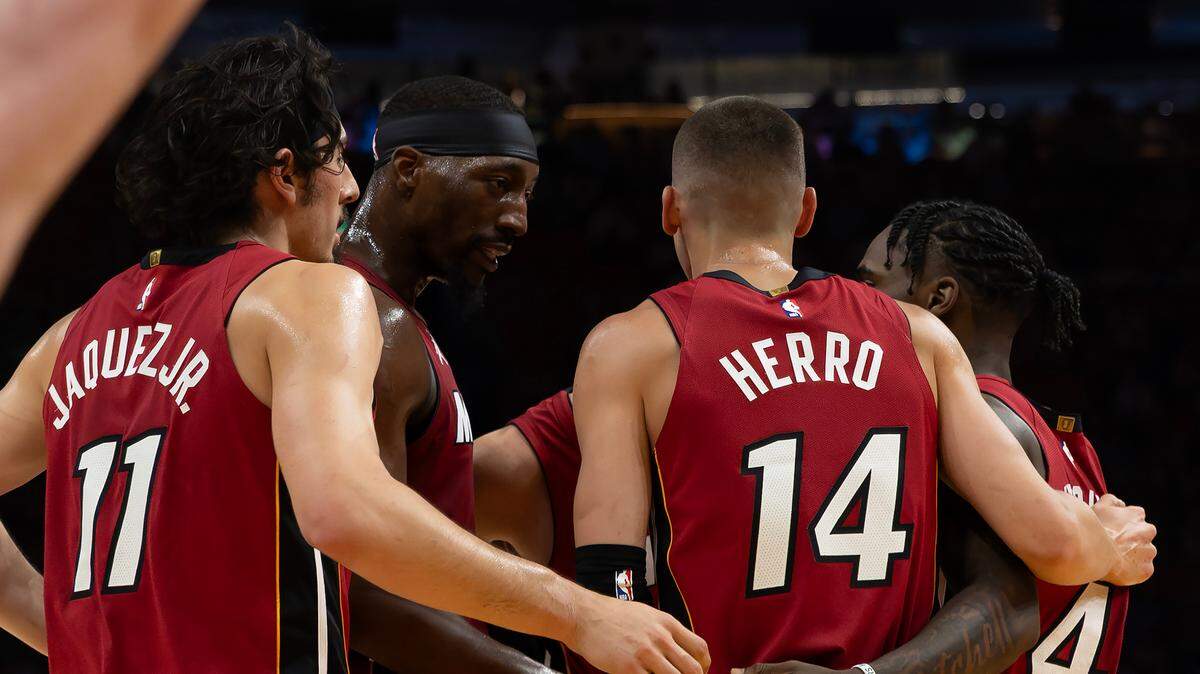 Miami Heat center Bam Adebayo (13) huddle with teammates Jaime Jaquez Jr. (11) Duncan Robinson (55) and Davion Mitchell (45) and Tyler Herro (14) during the first half of their NBA game against the Boston Celtics at Kaseya Center on March 14, 2025, in Miami.