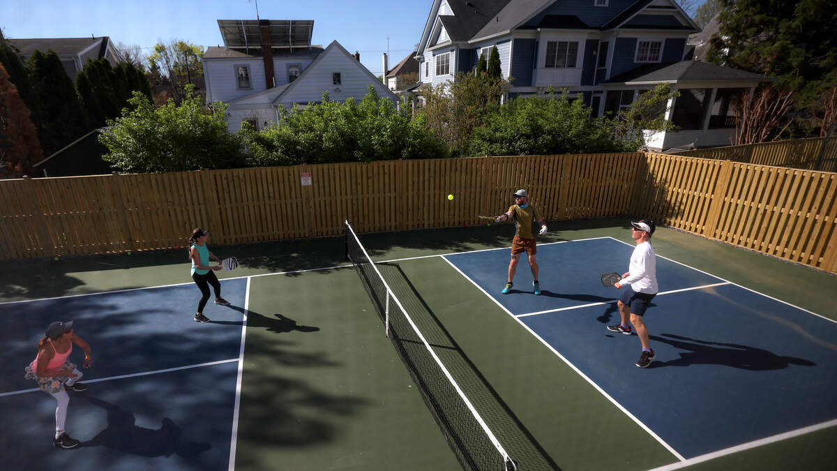 Michelle Ezra, Shelley Caplan, Rob Slattery and Kyle McKinney play pickleball on a backyard court on April 13, 2023 in Bethesda, Maryland.