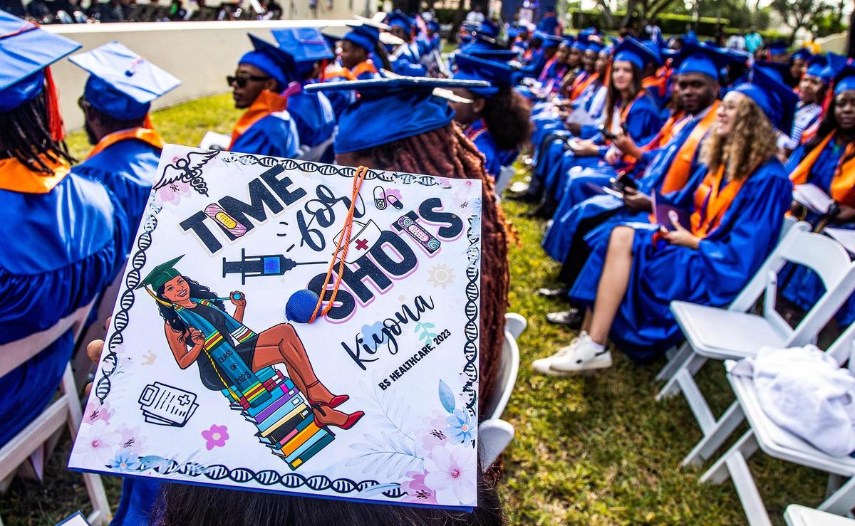 A student who got a healthcare degree wears a decorated mortarboard with shots, a band-aid and books at the spring commencement ceremony at Florida Memorial University in Miami Gardens, on Saturday May 6, 2023.