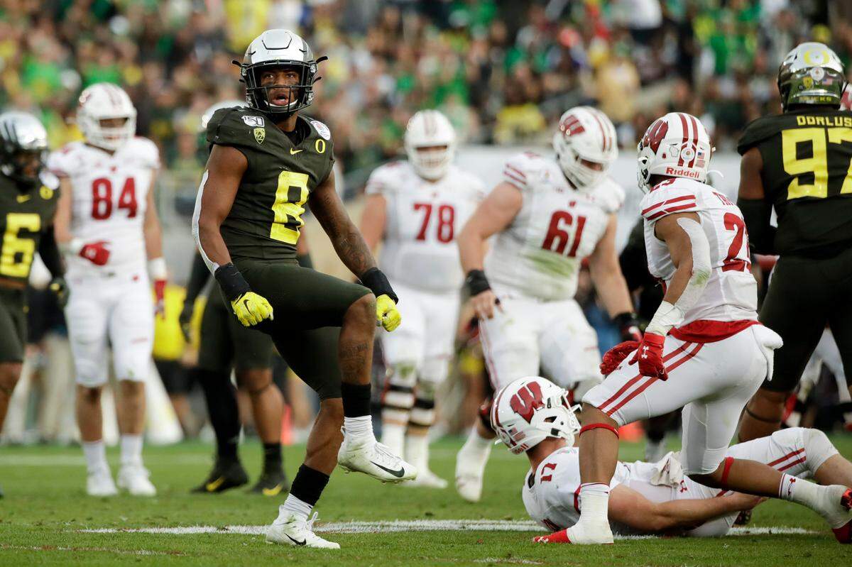 Oregon safety Jevon Holland celebrates after sacking Wisconsin quarterback Jack Coan during second half of the Rose Bowl NCAA college football game Wednesday, Jan. 1, 2020, in Pasadena, Calif. (AP Photo/Marcio Jose Sanchez)