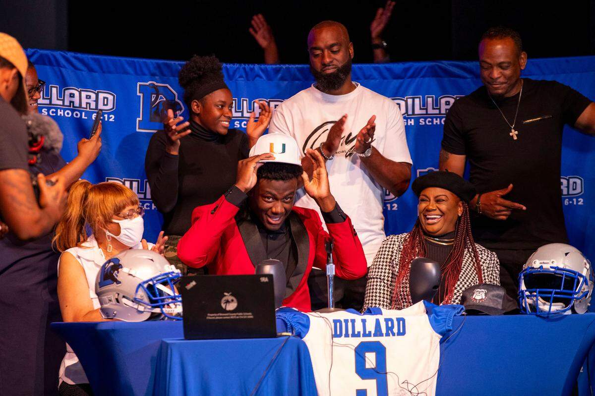 Four-star defensive lineman Nyjalik Kelly reacts after choosing to sign with University of Miami football during early National Signing Day at Dillard High School in Fort Lauderdale, Florida, on Wednesday, December 15, 2021. Kelly made a recent decision to switch his school of choice from Oregon to Miami after the Hurricanes brought on Mario Cristobal as head coach.