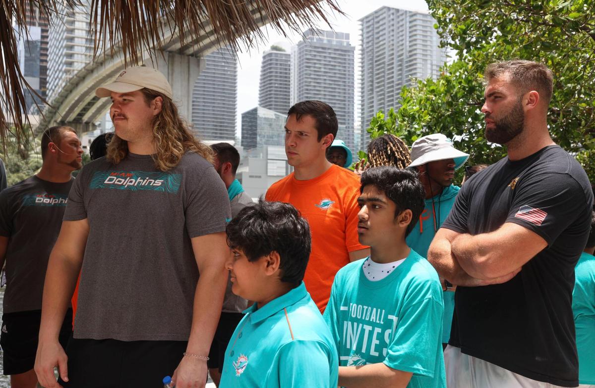 Clockwise from left: Blaise Andries, offensive lineman of the Miami Dolphins rookie class, Tanner Conner, tight end, and Kellen Diesch, another offensive lineman, listen to a historic walking tour with Bilan Siddiqui, 14, and Zain Khan, 11, kids from the Islamic Center of Greater Miami, during a historic walking tour of Downtown Miami on Wednesday, June 15, 2022, beginning with tour leaders at the History Miami Museum.