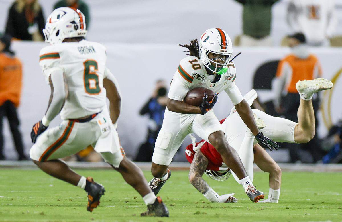 Miami Hurricanes wide receiver Malachi Toney (10) returns a punt in the first half of the College Football Playoff National Championship Game against the Indiana Hoosiers at Hard Rock Stadium in Miami Gardens, Florida, on Monday, January 19, 2026.
