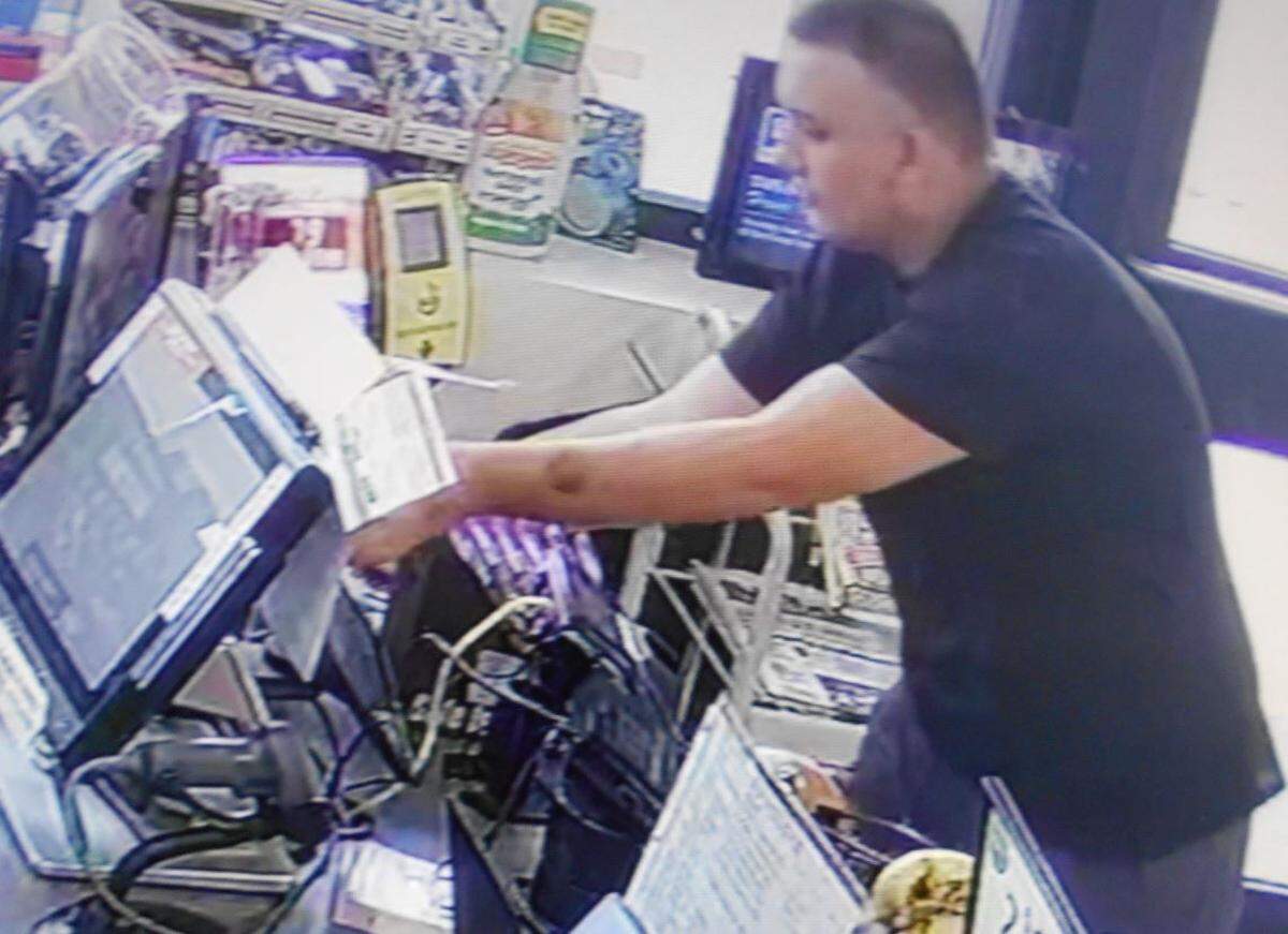 A surveillance video still showing, Volusia County Sheriff’s Office says, the theft of the donation jar