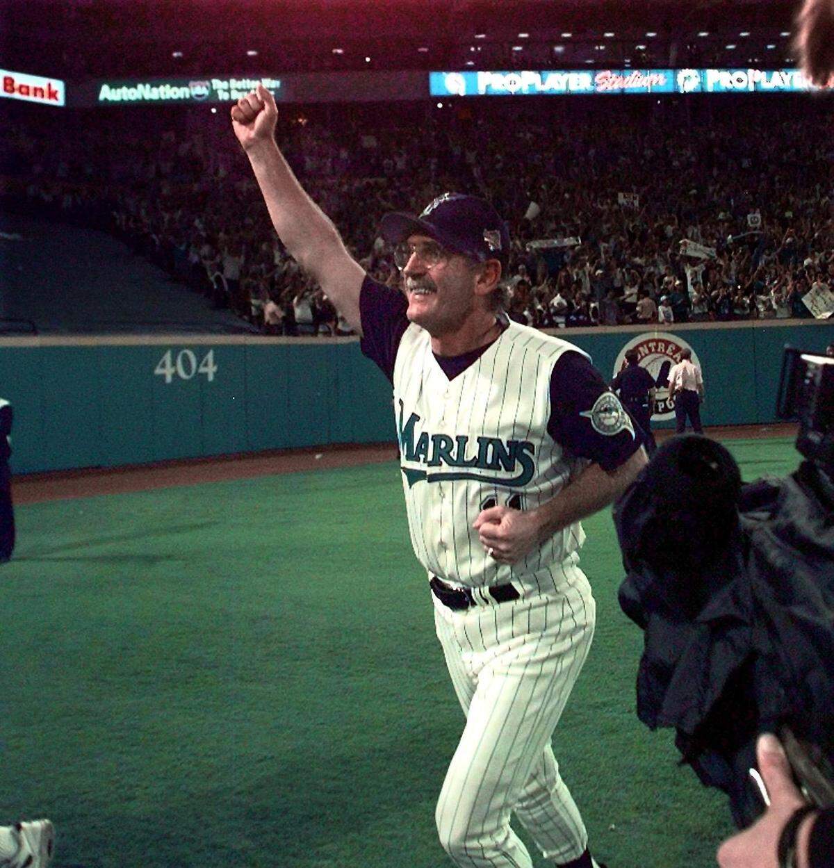 A very happy Marlins Manager Jim Leyland circles the field after winning the World Series in 1997.