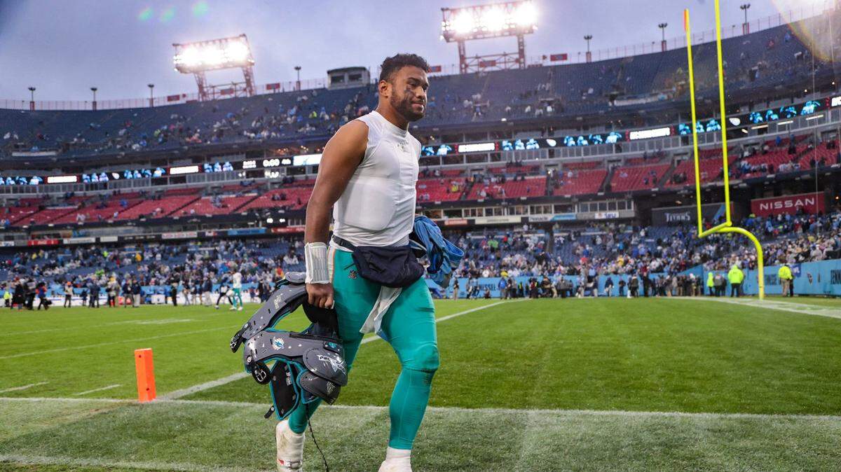Miami Dolphins quarterback Tua Tagovailoa (1) runs off the field after the Tennessee Titans defeat the Dolphins 34-3 at Nissan Stadium in Nashville, Tennessee on Sunday, January 2, 2022.