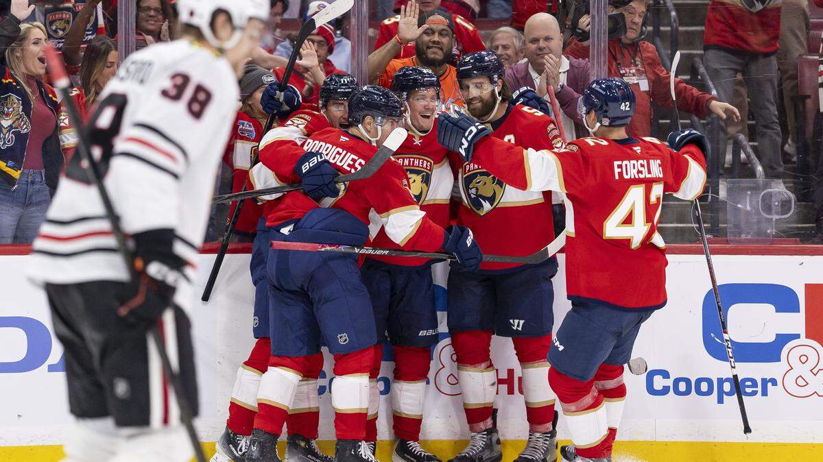Florida Panthers center Jesper Boqvist (70) celebrates with his teammates after scoring against Chicago Blackhawks goaltender Spencer Knight (30) in the third period of their NHL game at Amerant Bank Arena on Tuesday, Oct. 7, 2025, in Sunrise, Fla.