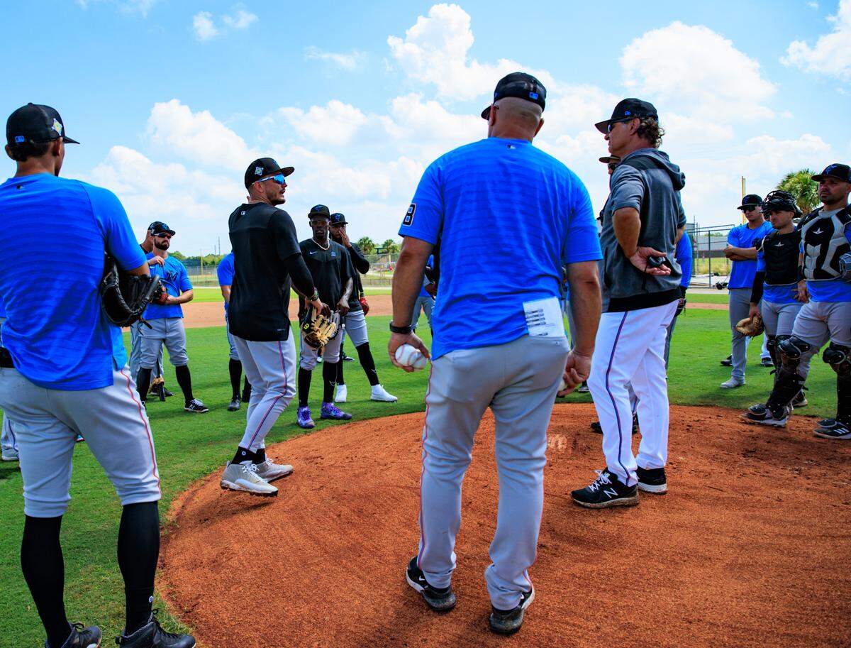 Miami Marlins shortstop Miguel Rojas speaks to coaches and teammates during their spring training workout at Roger Dean Stadium on Thursday, March 17, 2022 in Jupiter, FL.