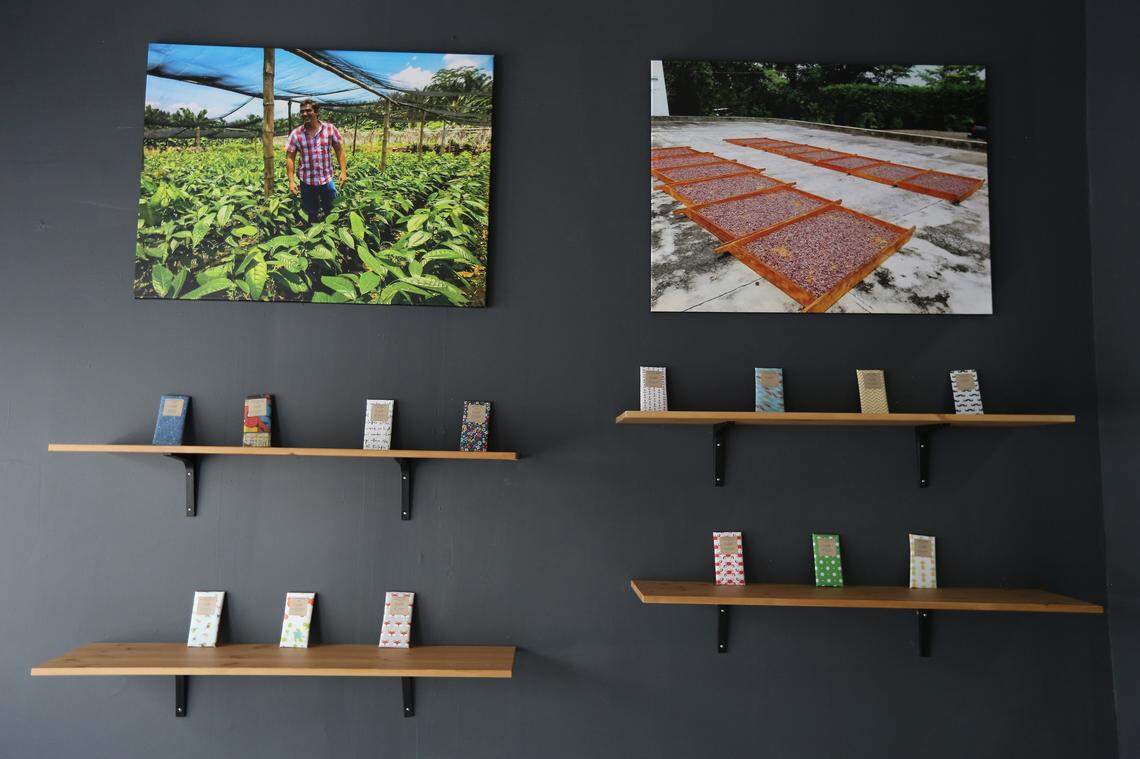 Exquisito Chocolates is opening Miami's first chocolate factory in Little Havana. Handmade and handwrapped chocolate bars line the shelves in the lobby of the factory underneath photos of the farms where some of the cocoa beans are purchased.