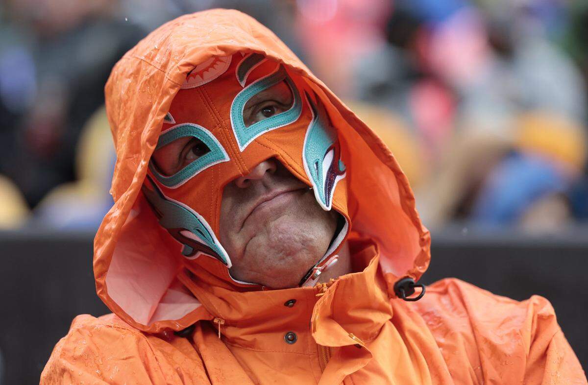 Miami Dolphins fan Bob Sampson reacts as the Miami Dolphins trail the Cleveland Browns in the first half of an NFL football game at Huntington Bank Field in Cleveland, Ohio, on Sunday, October 19, 2025.
