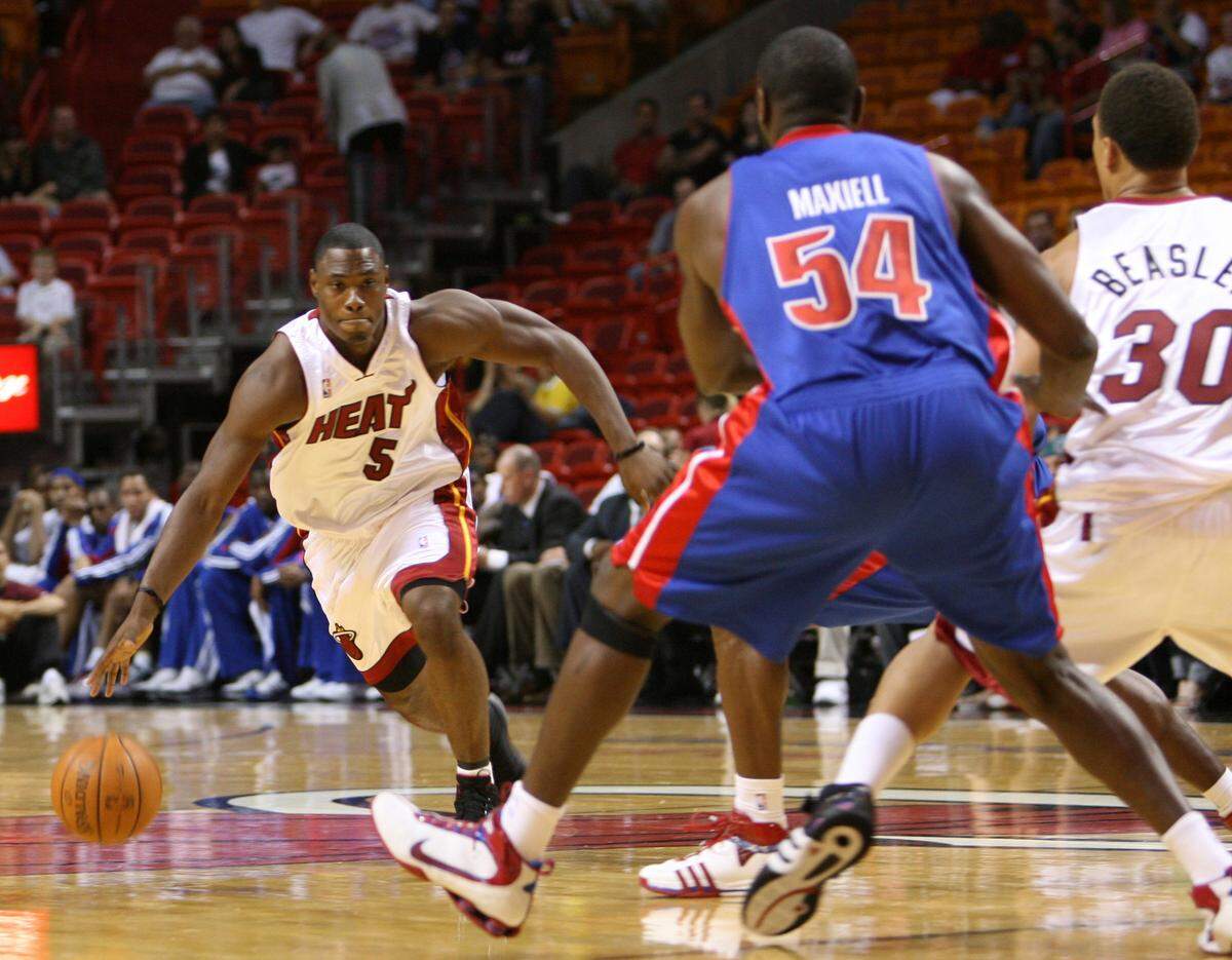 Miami Heat Marcus Banks drives past against Jason Maxiell  of the Detroit Pistons during first half of the opening preseason game at American Airlines Arena in Miami, Florida, on Sunday, October 05, 2008.
