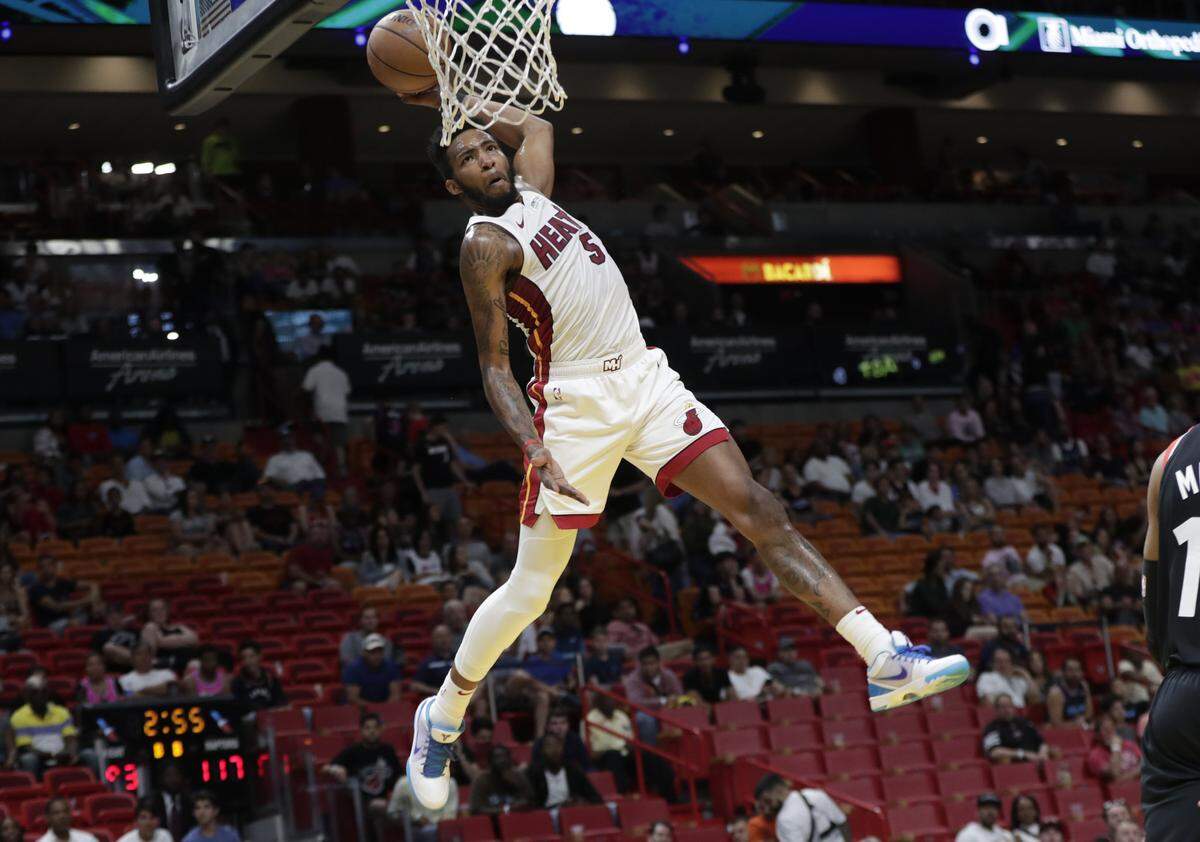 Miami Heat forward Derrick Jones Jr. (5) dunks during the second half of an NBA basketball game against the Toronto Raptors, Sunday, March 10, 2019, in Miami.